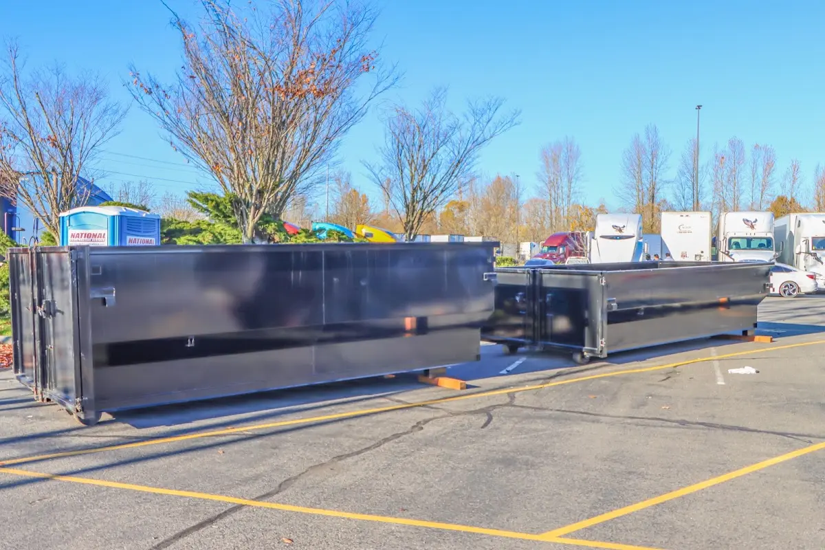 Professional dumpster rental service with roll-off container on residential driveway in Deale